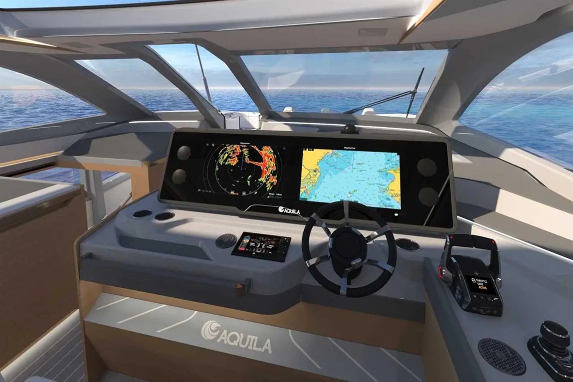Modern yacht cockpit showcasing navigation screens, radar, and a steering wheel with a clear ocean view. Brand: Aquila.